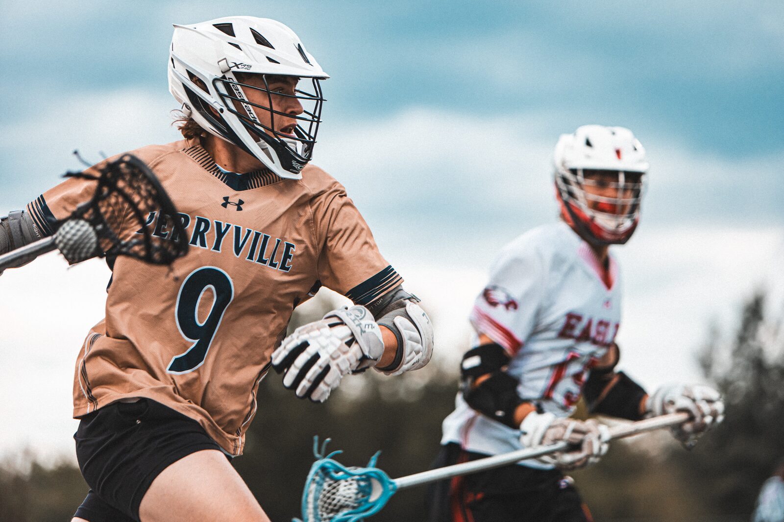 Lacrosse attacker dodging past a defender with the ball in his stick
