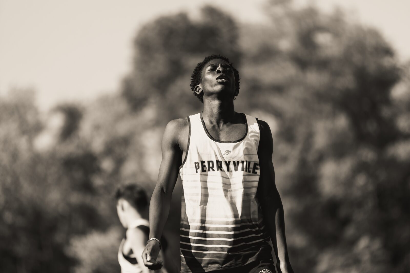Black and white photo of a runner walking back after finishing a race