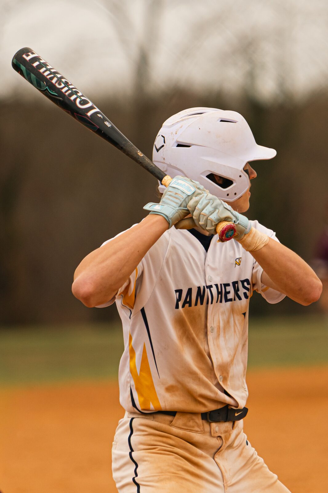 Batter swinging through the zone with the bat blurred by the speed
